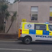 A police vehicle beside the steps to Castle Hill this evening