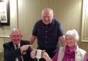Gil and Kay Gray receive the Jim Horton Trophy from Jim Jackson, Hunterston Rotary Club's Quiz master, centre