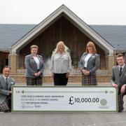 Carol-Anne Lamont of St Vincent's Hospice receiving a cheque for £10,000 from the staff at Clyde Crematorium.
