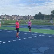 The Golden Oldies ladies are ready to play a game of doubles.