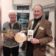 Donald Mclarty, (left) chairman of the Three Towns and District Men’s Shed with Hunterston Rotary President Gib Fitzgibbon and some of the items made by the Men’s Shed team.