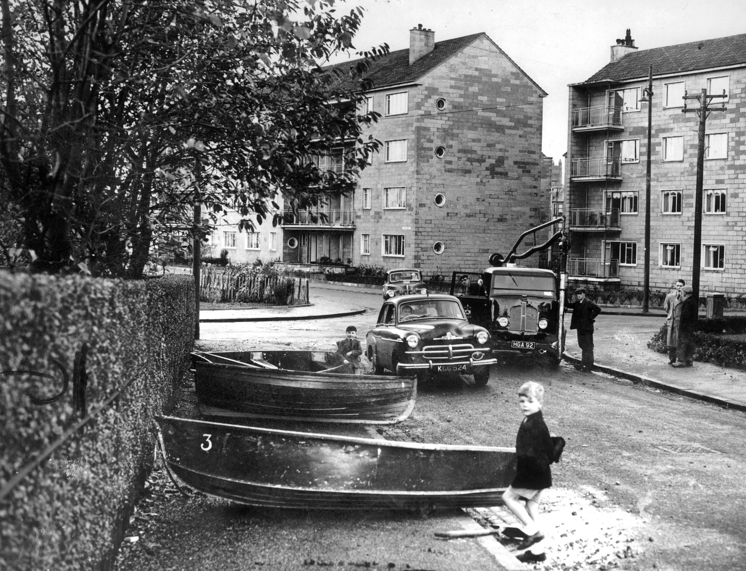 Flooding at Nether Auldhouse in 1954 meant boats had to be used to ferry residents to safety. Pic: Herald and Times