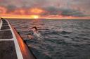 Andy Donaldson swims into the beautiful sunrise as he swims across the North Channel.