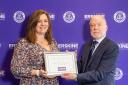 Krystyna receives her award from Erskine chairman Stuart Aitkenhead