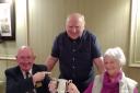 Gil and Kay Gray receive the Jim Horton Trophy from Jim Jackson, Hunterston Rotary Club's Quiz master, centre