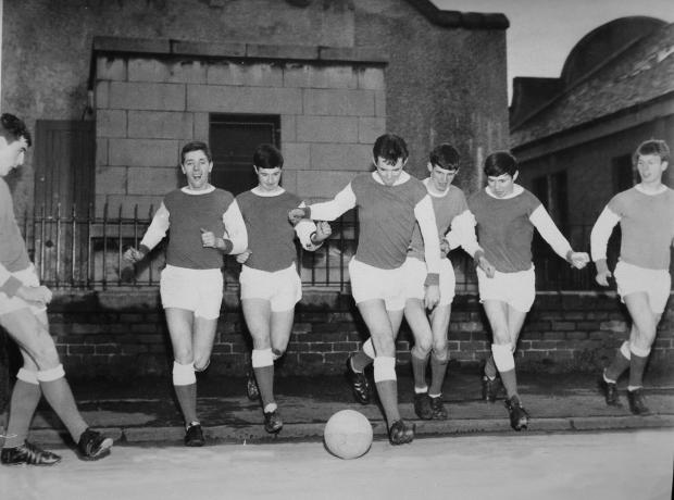 Ardrossan and Saltcoats Herald: Young Possil YM footballers in Arsenal strips pictured in Possil in the 1960s.  Bobby Dinnie, now age 89, a retired football scout, was involved with the Possil YM football team for over 60 years and was responsible for discovering footballers Kenny