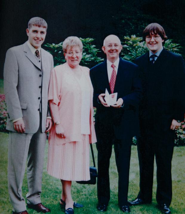 Ardrossan and Saltcoats Herald: Bobby Dinnie pictured (with his MBE) with his wife Betty and sons Robert, left and Russell on the right. Bobby, a Korean war veteran,  now age 89, is a retired football scout, was involved with the Possil YM football team for over 60 years and was