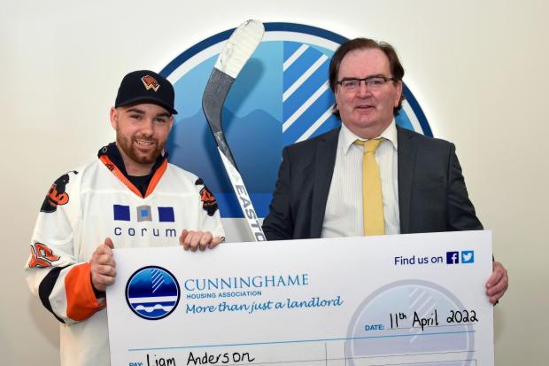Liam Anderson receives the donation