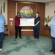 Staff are presented with the cheque worth £1,500