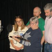The cast of the audio recording at work