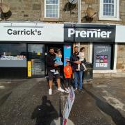 Charanjit and Hardeep Binning outside the newly revamped Carrick's store with their own children.