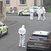 Police pictured at the scene of the alleged incident.