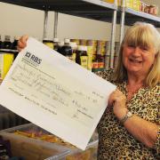 Angela with her cheque for the food larder