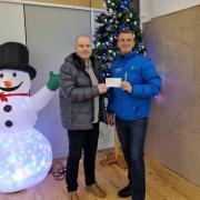 NASA chair Mark Wilson hands a cheque to Eddie Gorman from Harbour Ayrshire
