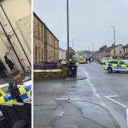 What appeared to be armed police were seen surrounding a house after Canal Street was partially locked down by police.