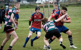 Accies' player Calum Houston carrying the ball hard into contact