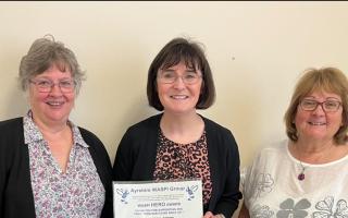 MP Patricia Gibson receives the award from Frances and Lynn of Ayrshire WASPI