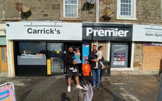 Charanjit and Hardeep Binning outside the newly revamped Carrick's store with their own children.